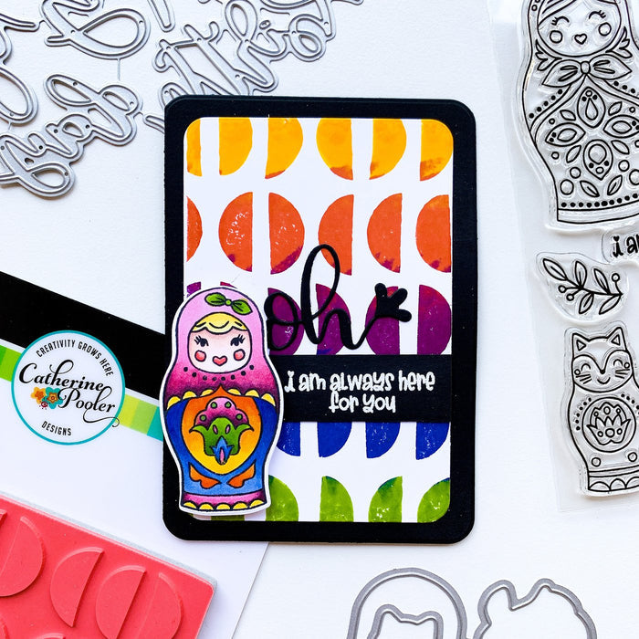 Catherine Pooler - Die Set - We Fit. Remind your friends and loved ones they "just fit" by sending cards made with the We Fit Dies and coordinating We Fit Stamps. Use the dies to cut out one of the three dolls, the cat doll or one of the extras. Layer the pieces to create dimension and fun on all your friendly cards. Available at Embellish Away located in Bowmanville Ontario Canada. Card example by brand ambassador.