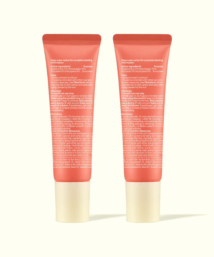 Two coral-colored tubes of Lip 30 Duo: Sunset Cove + Sunset Cove by Sun Bum showing back labels and ingredients.