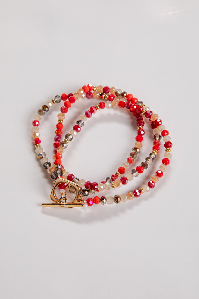 Beaded necklace with a gold clasp on a light gray background