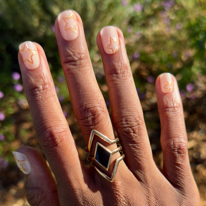 Puffy Gold Stars - Press-On | Extra Short | Squoval milky neutral nails with 3D gold star outlines for easy at-home mani