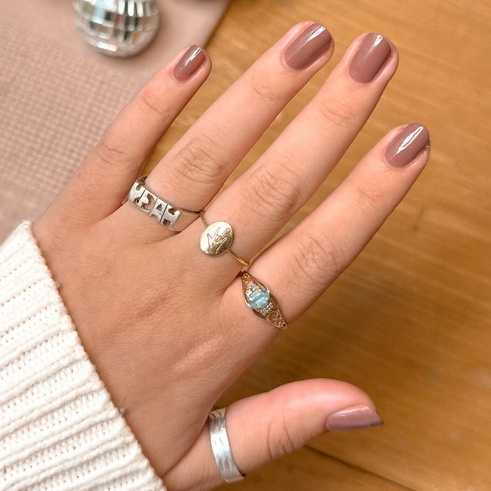 Hand with neutral warm skin tone wearing Shacket gel polish in warm rose neutral for a polished manicure at home
