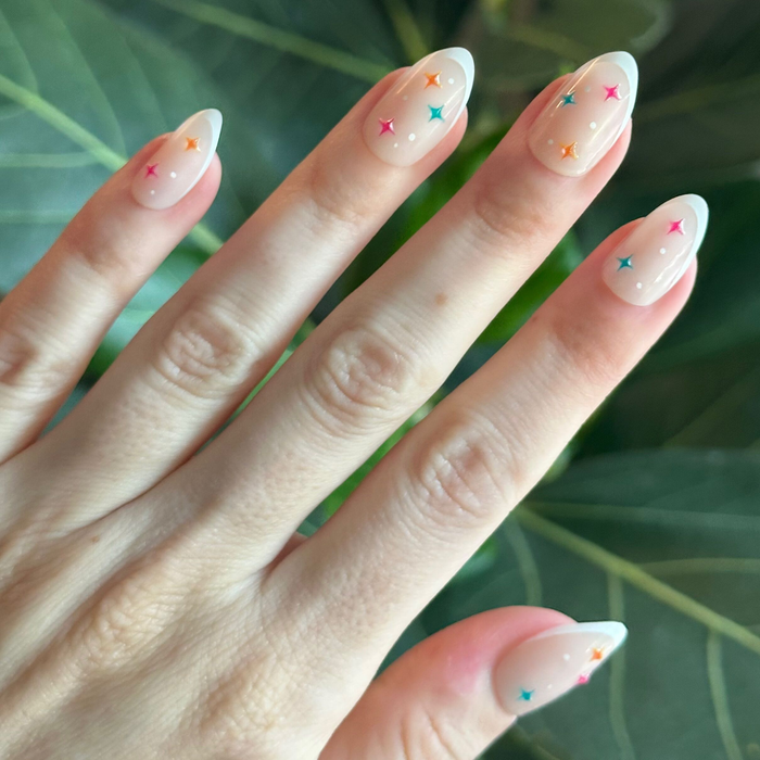 3D Gem French - Press-On | Medium | Almond natural press-on nails with colorful star accents for an easy at-home manicure