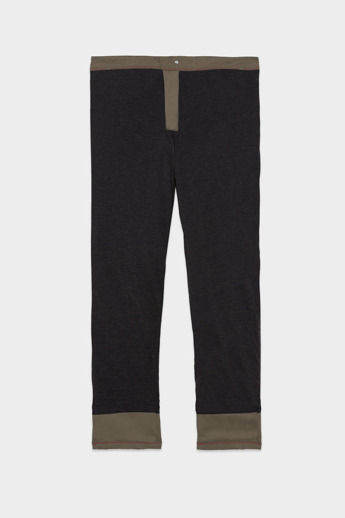 The 686 Mens Everywhere Merino-Lined Pant - Slim Fit by 686, shown flat on a white background, features black fabric with an olive green waistband, fly, and cuffs‚Äîdesigned to keep you warm and dry in cold conditions.