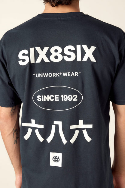 A person wearing the 686 Unwork Wear Authentic S/S Tee in mens black cotton, featuring white SIX8SIX, UNWORK WEAR, SINCE 1992, ÂÖ≠ÂÖ´ÂÖ≠ text on the back and a small circular logo at the bottom. Brand: 686.