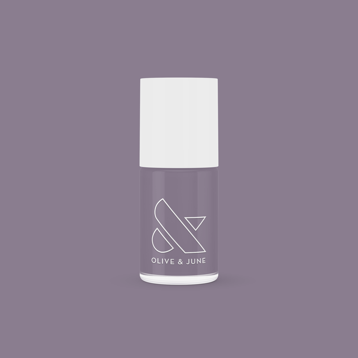 Olive and June Art Class nail polish bottle in muted eggplant shade on matching purple background