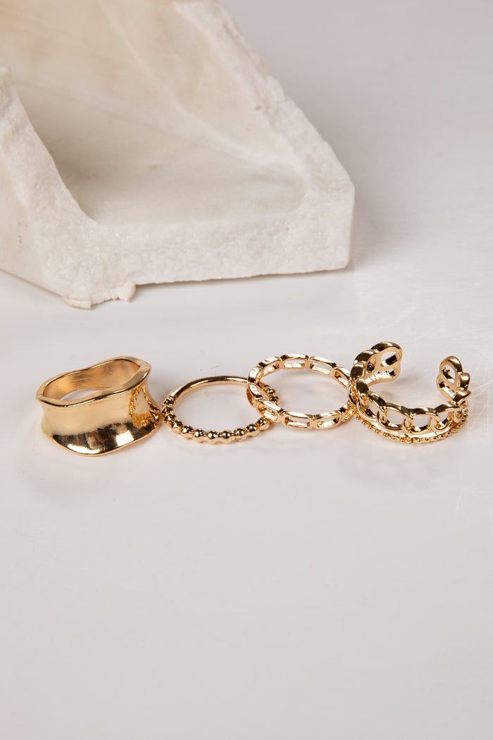 Set of gold rings on a light gray background