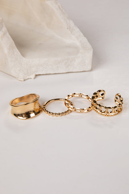 Set of gold rings on a light gray background