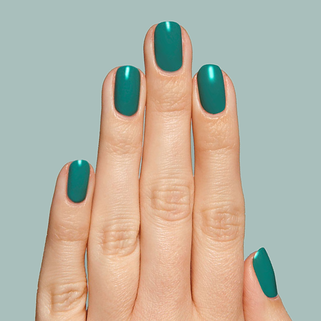 Hand with nails painted in rich emerald green shade Besties for a smooth, long-lasting manicure by Olive and June