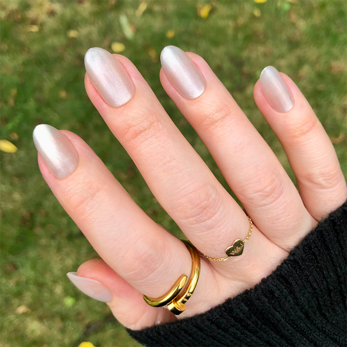 CDJ Velvet - Press-On | Medium | Oval nails in soft neutral shimmer with a smooth velvet finish on natural hand outdoors