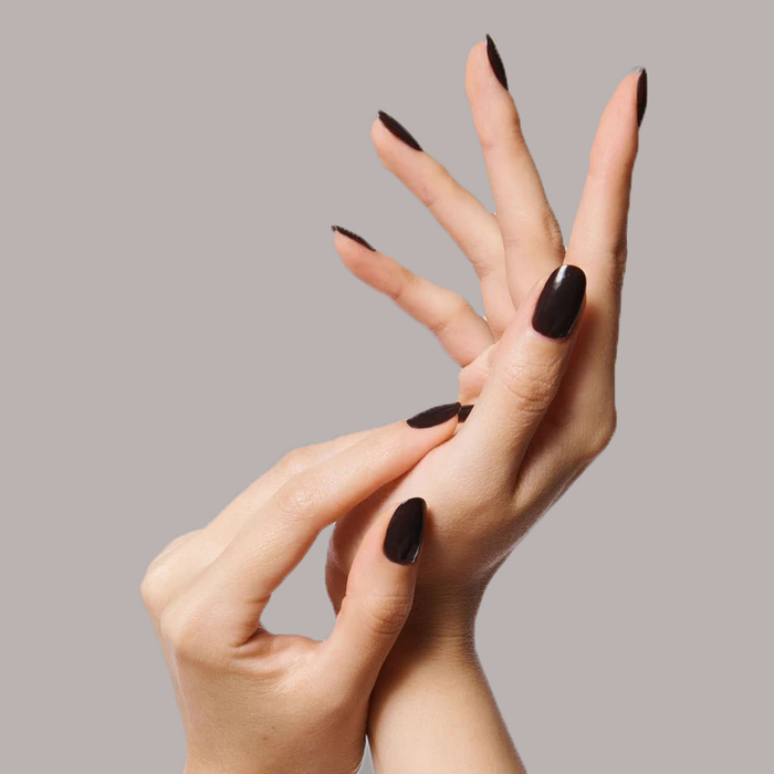 Hands with nails painted in silky sable brown CN polish showing a smooth long-lasting mani finish