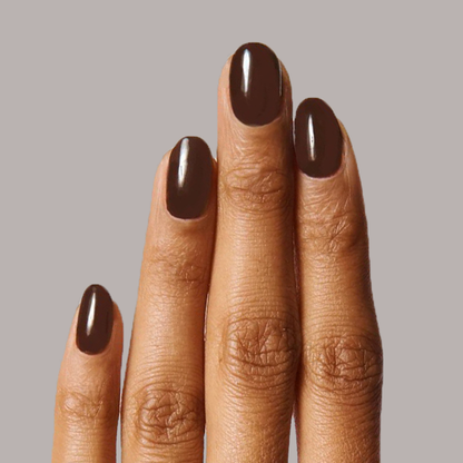 Fingers with nails coated in glossy CN polish showing a smooth, long-lasting mani in rich sable brown shade