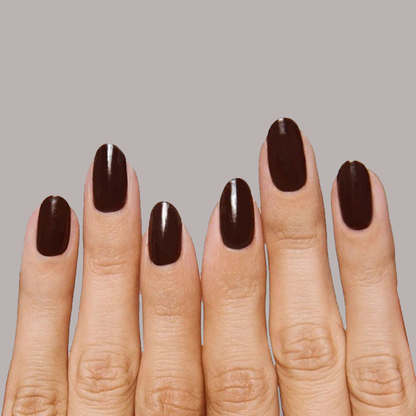 Hand with nails painted in rich sable brown CN polish showing a smooth, long-lasting manicure finish