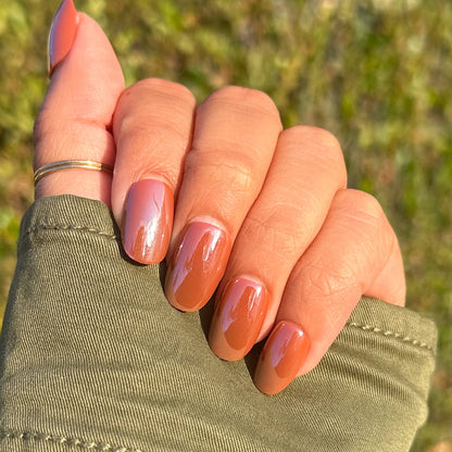 Cocoa Chrome - Press-On | Short | Round short round nails with shiny dark brown chrome finish on hand outdoors with rings