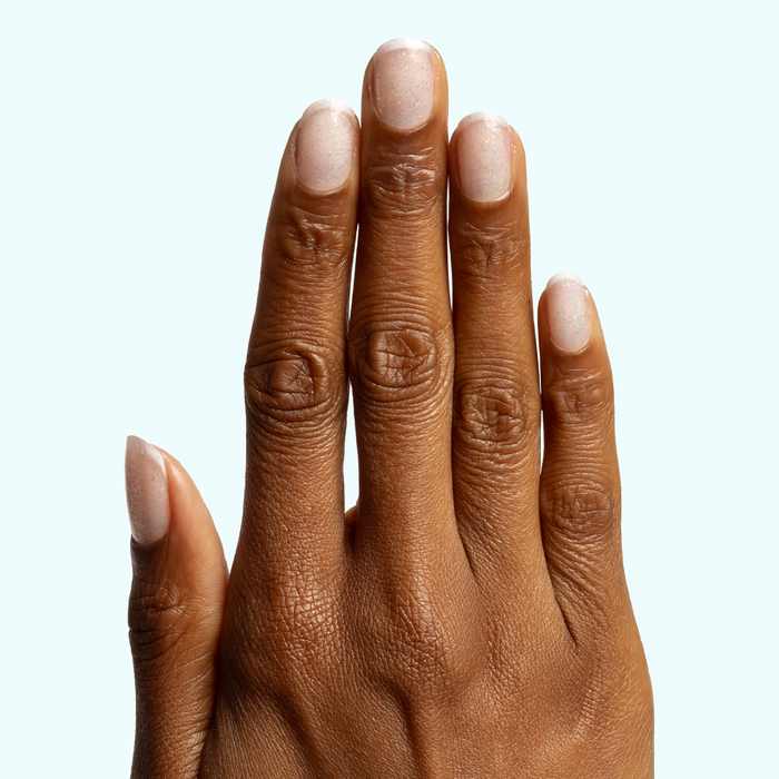 Diamonds Are a Mani’s Best Friend sheer iridescent polish on natural nails for a subtle sparkling at-home manicure look