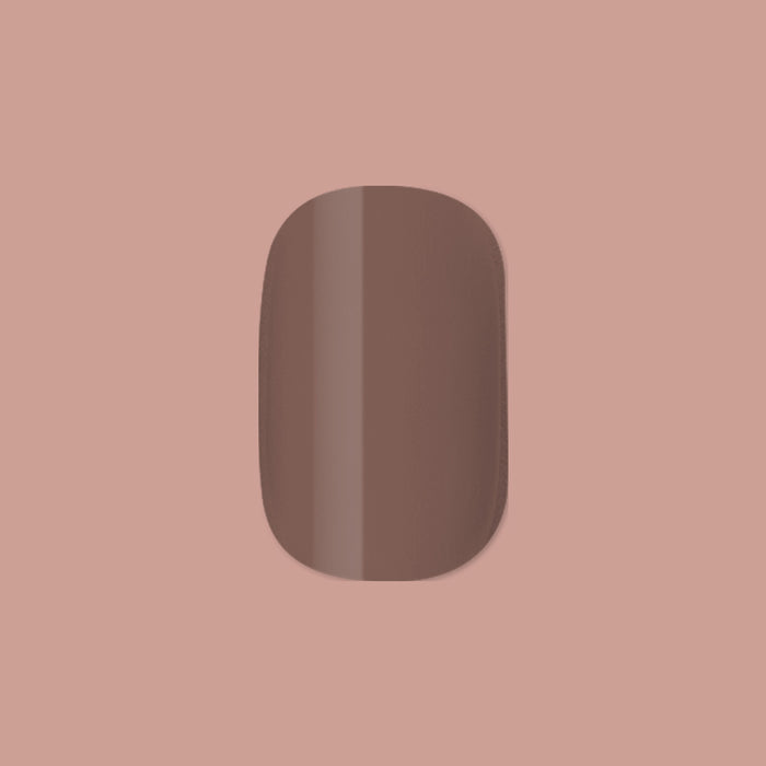 Fawn | Extra Short | Squoval - Tab Press-On displaying a single minky brown neutral false nail on soft brown background