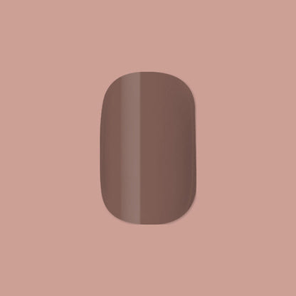 Fawn | Extra Short | Squoval - Tab Press-On displaying a single minky brown neutral false nail on soft brown background