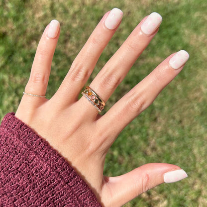 Heart Shower | Extra Short | Squoval - Tab Press-On nails with soft pink hearts on neutral base shown on hand outdoors with rings