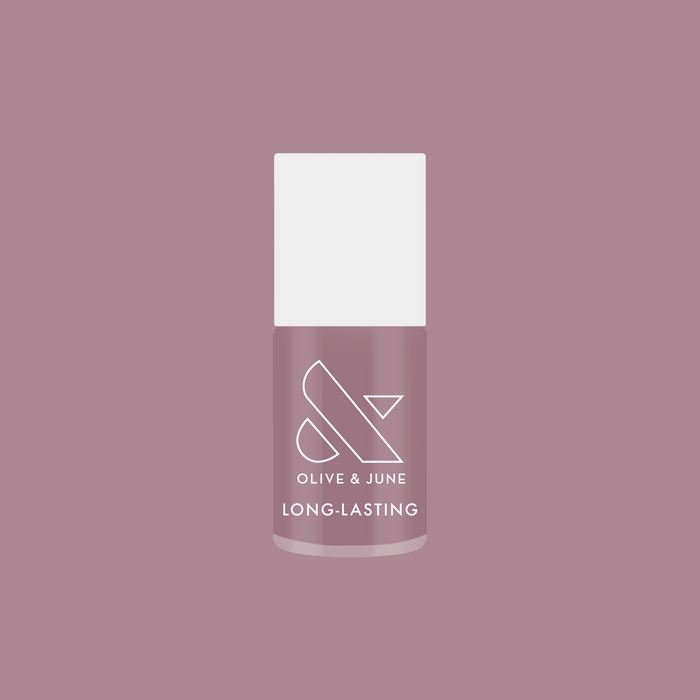 Bottle of I Mani in Meetings long-lasting nail polish in midtone mauve purple against matching background