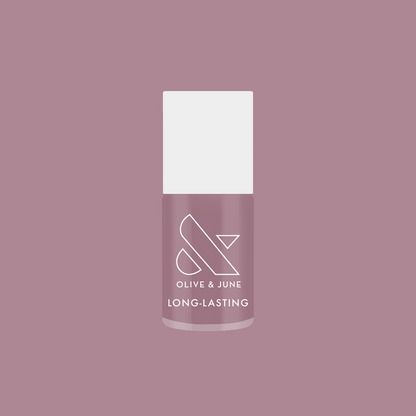 Bottle of I Mani in Meetings long-lasting nail polish in midtone mauve purple against matching background