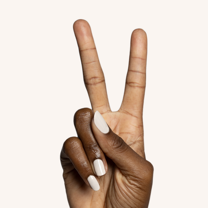 Hand displaying peace sign with nails painted in neutral beige It's Chilly! long-lasting gel polish