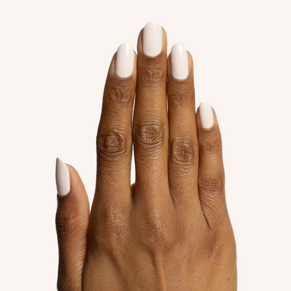 Hand with smooth medium brown skin wearing It's Chilly! long-lasting neutral beige gel polish manicure