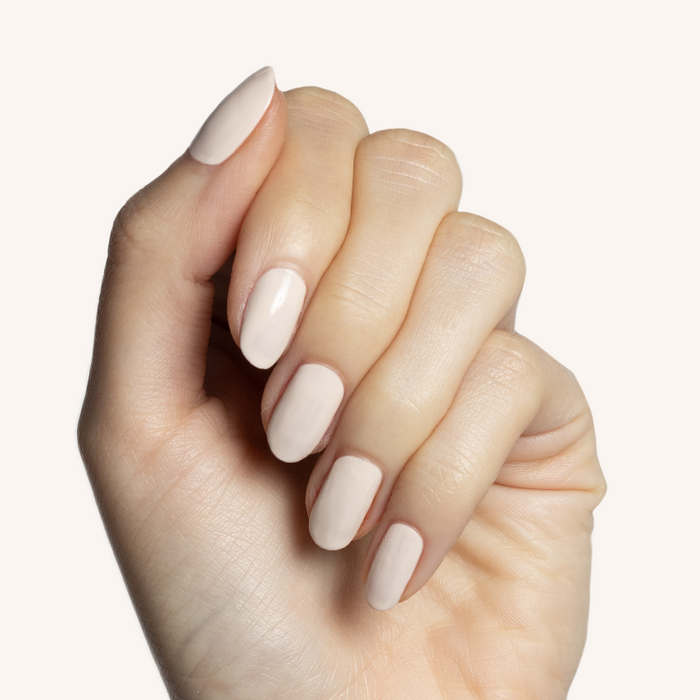 Hand with light skin tone showing nails painted with It's Chilly! long-lasting neutral beige gel polish manicure