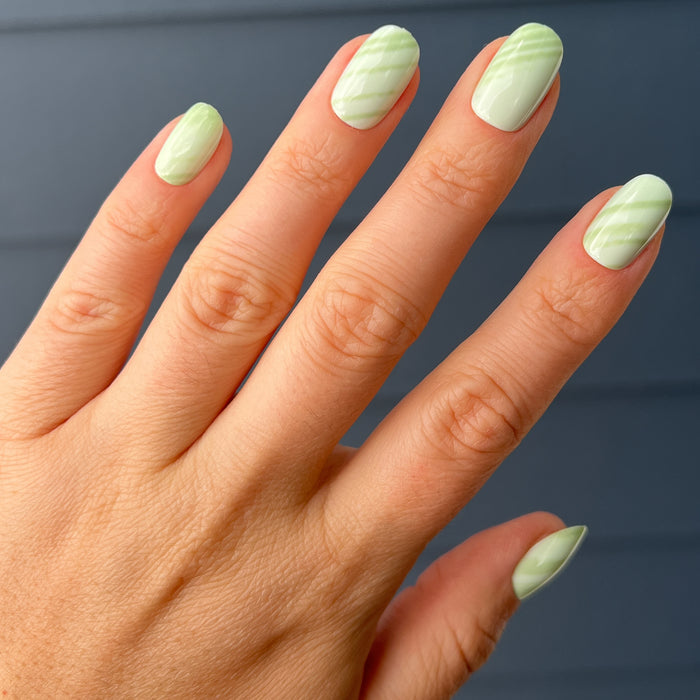 Jade Stone | Round | Short press-on nails with light green striped jade design in short round shape for easy at-home mani