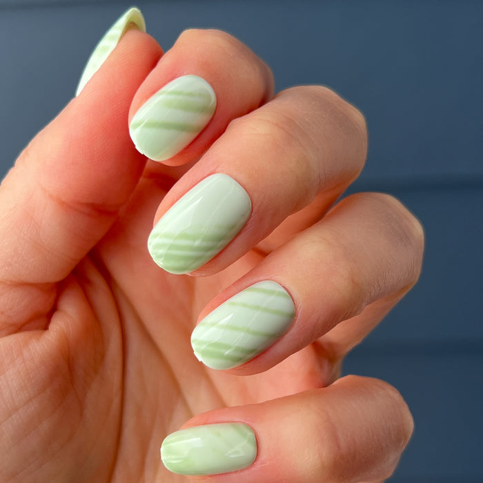 Jade Stone | Round | Short press-on nails in a short round shape with soft green jade stripes for an easy at-home mani