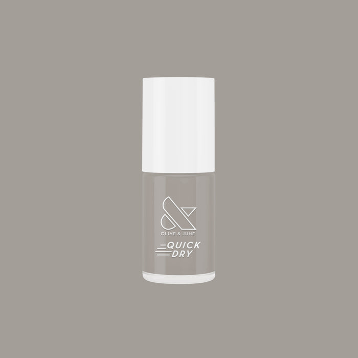 Bottle of Olive and June Koala quick dry nail polish in neutral soft grey shade on matching background