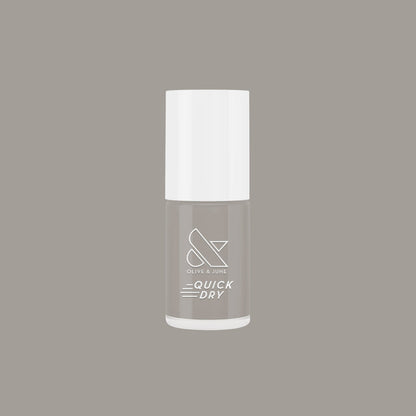 Bottle of Olive and June Koala quick dry nail polish in neutral soft grey shade on matching background