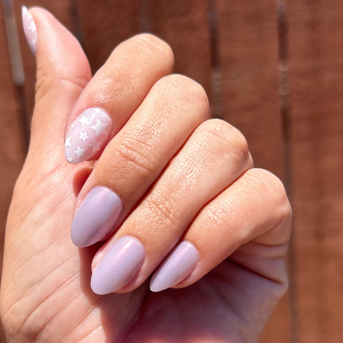 Hand with Mermaid Stars - Press-On | Medium | Almond nails in soft purple and white star pattern for easy at-home mani.