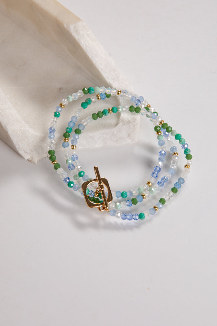 Beaded necklace with a gold clasp on a light background