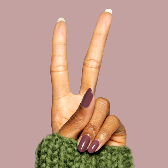 Hand showing peace sign with almond-shaped nails painted dusty deep rose brown Patron of the Arts gel polish