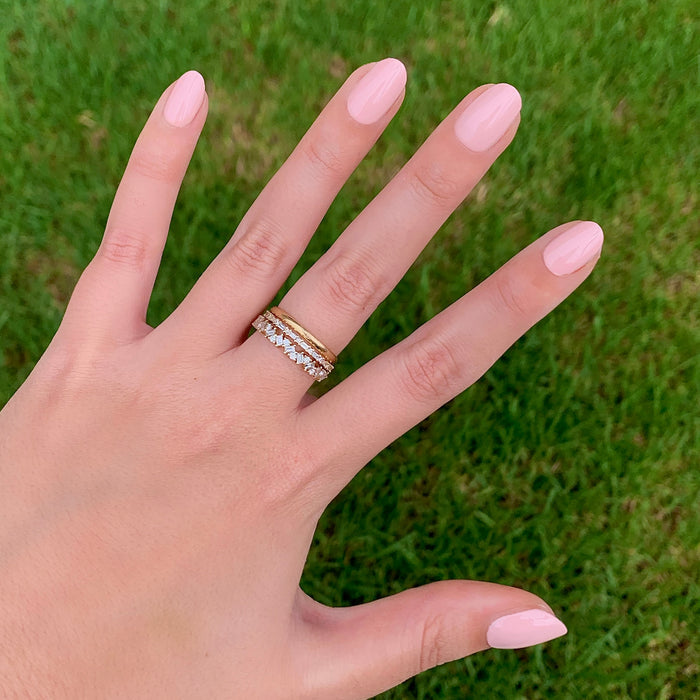 Hand showing nails polished in Pointe ballerina pink for a clean, natural looking at-home manicure and pedicure