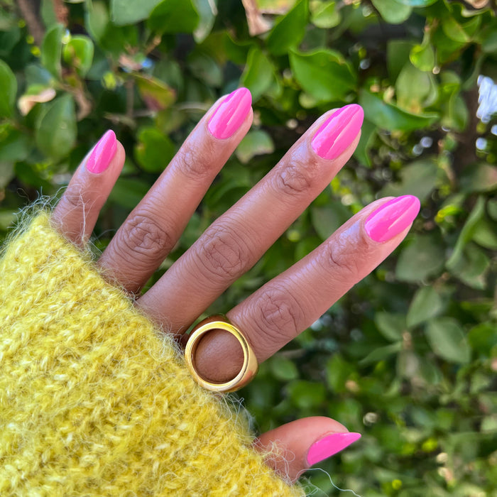 Hand with nails painted in Prom bold magenta pink polish showcasing a glossy and stylish at-home manicure look