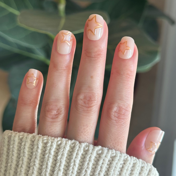 Puffy Gold Stars - Press-On | Extra Short | Squoval milky neutral nails with raised gold star outlines for easy at-home mani