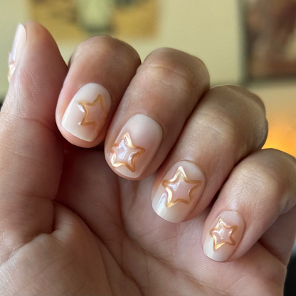 Puffy Gold Stars - Press-On | Extra Short | Squoval milky neutral nails with raised gold star accents for easy at-home mani