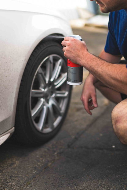 Person spraying KochChemie Reactive Rust Remover on a car
