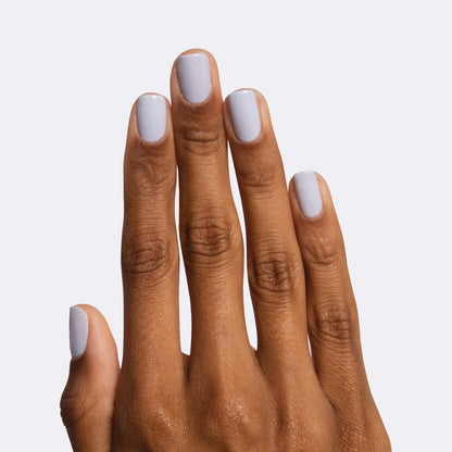 Hand with nails painted in icy pastel blue Rink polish for a smooth and quick dry at-home manicure look