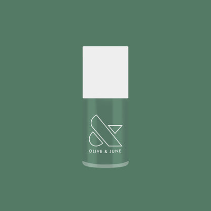 Still Life of Flowers gel polish bottle in cool mossy green shade against solid matching green background