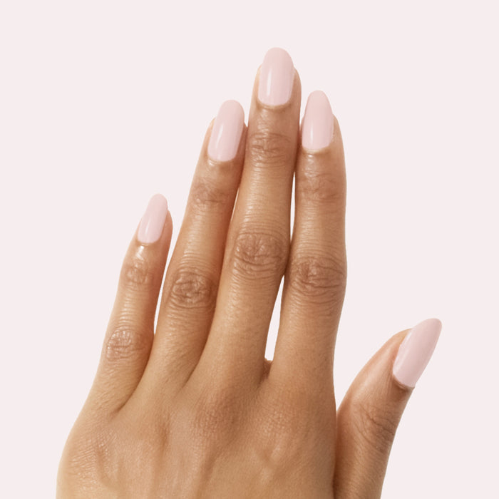 Hand with smooth vintage rose pink manicure featuring Study Hall nail polish on a pale pink background