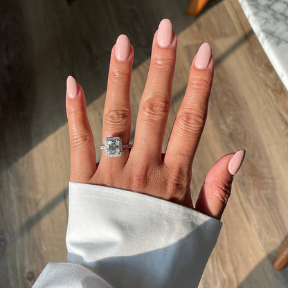 Hand showing glossy manicure in Study Hall vintage rose pink long-lasting polish with natural light on wooden floor background