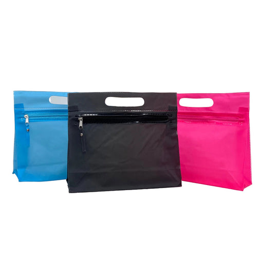Three zip-top pouches with die-cut handles in blue, black, and pink, arranged side-by-side on a white studio background.