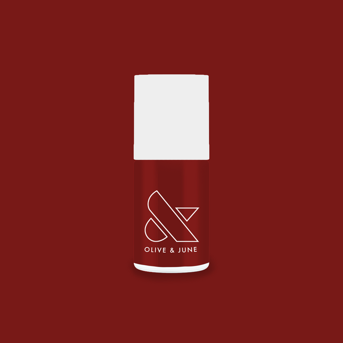Olive and June Team Spirit nail polish bottle in deep maroon shade for long-lasting at-home manicures and pedis