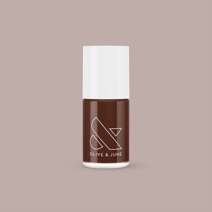 Tip Your Barista dark espresso brown long-lasting nail polish bottle with white cap on taupe background