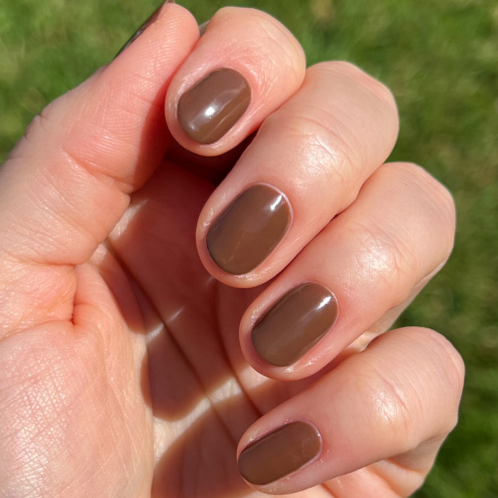 Tip Your Barista espresso brown quick dry polish on short natural nails in bright outdoor light showing smooth finish