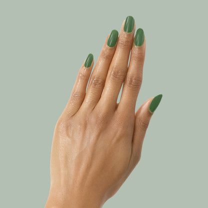 Hand with almond-shaped nails coated in Touchdown! polish, a fresh turf green for a smooth, long-lasting mani by Olive and June