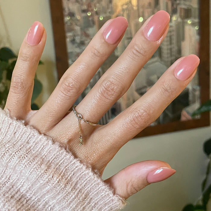 World Lit Jelly - Press-On | Short | Round sheer mauve nails on hand with cozy knit sleeve for at-home mani look